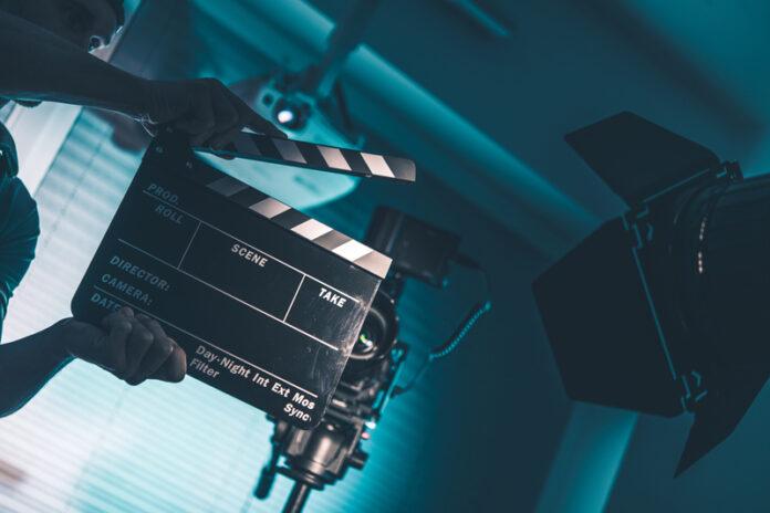 film production, movie set, clapperboard, camera equipment, filming, director, cinematography, studio lighting