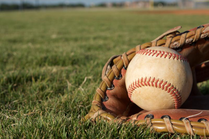 Baseball and Glove on Field