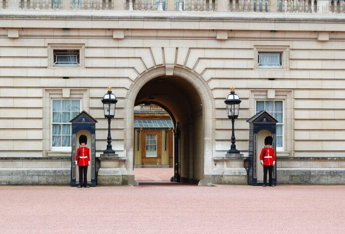 Royal Guards at Buckingham Palace. The Royal Guards dressed in their traditional unforms standing at the gates of Buckingham Palace in London 5