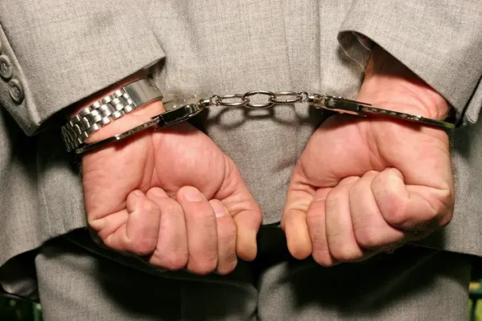 Former President Imprisoned For 25 Years (handcuffs dreamstime_s_1688192)